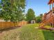 Fenced backyard featuring a lawn and a storage shed providing a serene outdoor setting at 15769 E Greenwood Dr, Aurora, CO 80013