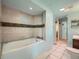 Bathroom featuring a tub with a tiled wall and a vanity with a mirror at 15769 E Greenwood Dr, Aurora, CO 80013