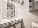 Traditional bathroom with single sink vanity, decorative lighting, and shower/tub combo at 15769 E Greenwood Dr, Aurora, CO 80013