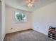 Simple bedroom with carpet flooring and a bright window, offering ample natural light at 15769 E Greenwood Dr, Aurora, CO 80013