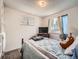 Cozy bedroom with neutral walls, carpeted floor, and a large window with natural light at 15769 E Greenwood Dr, Aurora, CO 80013