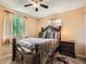 Comfortable bedroom featuring a ceiling fan, plush bedding, and natural light from the window at 15769 E Greenwood Dr, Aurora, CO 80013