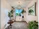 Bright dining room with modern chandelier, large window, and ample natural light at 15769 E Greenwood Dr, Aurora, CO 80013