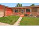 Up close view of charming brick and siding single Gathering home with well kept front yard at 15769 E Greenwood Dr, Aurora, CO 80013