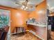 Cozy kitchen with bar seating, wood floors, modern appliances, and bright natural light at 15769 E Greenwood Dr, Aurora, CO 80013