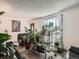 Cozy living room filled with plants, large window, and comfortable furniture at 15769 E Greenwood Dr, Aurora, CO 80013