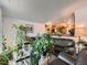 Cozy living room filled with plants, and comfortable furniture looking into dining and kitchen areas at 15769 E Greenwood Dr, Aurora, CO 80013