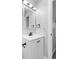 Modern bathroom with lighted mirror, white vanity, and black fixtures at 4672 S Lewiston Way, Aurora, CO 80015