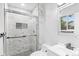 Elegant bathroom with marble shower, glass door, and modern fixtures at 4672 S Lewiston Way, Aurora, CO 80015