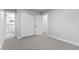 Bedroom boasts neutral carpet and a closet leading to bathroom with tiled shower at 4672 S Lewiston Way, Aurora, CO 80015