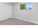 Bedroom featuring neutral carpet, closet, and a sunlit window at 4672 S Lewiston Way, Aurora, CO 80015
