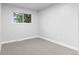 Bright bedroom featuring neutral carpet and a sunlit window at 4672 S Lewiston Way, Aurora, CO 80015