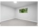 Bedroom featuring neutral carpet and a sunlit window at 4672 S Lewiston Way, Aurora, CO 80015