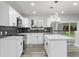 Open kitchen featuring modern appliances, a center island, and hardwood floors for seamless entertaining at 4672 S Lewiston Way, Aurora, CO 80015