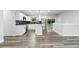 Modern kitchen with stainless steel appliances, center island, and sleek black backsplash at 4672 S Lewiston Way, Aurora, CO 80015