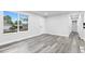 Bright living room featuring modern gray floors, neutral walls, and a large window at 4672 S Lewiston Way, Aurora, CO 80015