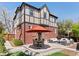 This lovely outdoor space features a beautiful patio area with elegant lounge furniture, a grill, and a dining set at 1024 S Columbine St, Denver, CO 80209