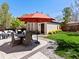 This fabulous backyard has an expansive patio with lounge seating, a dining set, a grill, and mature landscaping at 1024 S Columbine St, Denver, CO 80209
