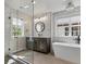Bright bathroom featuring a glass shower, stylish vanity and soaking tub at 1024 S Columbine St, Denver, CO 80209