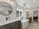 Modern bathroom featuring double sinks, soaking tub, and hexagon tile flooring at 1024 S Columbine St, Denver, CO 80209