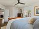 Bedroom featuring two bright windows, ceiling fan, and decorative dresser, offering a comfortable living space at 1024 S Columbine St, Denver, CO 80209