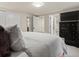 Bright bedroom boasts closet space, an ensuite bathroom and a television set atop a dresser at 1024 S Columbine St, Denver, CO 80209