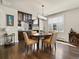 Elegant dining area with modern chandelier and view to the kitchen area at 1024 S Columbine St, Denver, CO 80209
