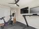 Spacious exercise room with treadmill and stationary bike, complete with dual screens for an immersive workout experience at 1024 S Columbine St, Denver, CO 80209