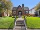 Beautiful brick home with manicured lawn, walkway, and classic architectural details at 1024 S Columbine St, Denver, CO 80209