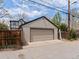 Exterior view of a detached garage showcasing neutral siding and a standard garage door for secure parking at 1024 S Columbine St, Denver, CO 80209