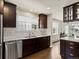 Bright kitchen featuring granite countertops, white tile backsplash, stainless steel appliances, and warm hardwood floors at 1024 S Columbine St, Denver, CO 80209