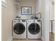 Laundry room featuring stacked washer and dryer with shelving above and a window that provides natural light at 1024 S Columbine St, Denver, CO 80209