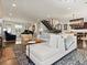 Open-concept living area with modern staircase and access to dining and kitchen at 1024 S Columbine St, Denver, CO 80209
