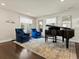 Formal living room featuring a grand piano, comfortable chairs, and elegant decor at 1024 S Columbine St, Denver, CO 80209