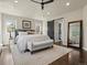 Bright main bedroom featuring a barn door to the closet and a large mirror at 1024 S Columbine St, Denver, CO 80209