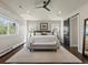 Main bedroom with bench, ceiling fan, and large windows that provides natural light and creates a relaxing atmosphere at 1024 S Columbine St, Denver, CO 80209