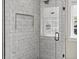 Close up on a modern shower featuring glass doors, tile surround, and window at 1024 S Columbine St, Denver, CO 80209