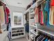 Walk-in closet with shelving for shoes, clothing and accessories, and a window for natural light at 1024 S Columbine St, Denver, CO 80209