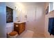 Well-lit bathroom showcasing a wood vanity with a mirror, a toilet, and a white door for added privacy at 4945 Twin Lakes Rd # 44, Boulder, CO 80301