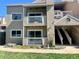 Beige two-story condo featuring dual balconies, white railings, and manicured landscaping on a sunny day at 4945 Twin Lakes Rd # 44, Boulder, CO 80301