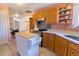 Bright, pink kitchen with an island, updated appliances, and views of the connected dining area at 4945 Twin Lakes Rd # 44, Boulder, CO 80301