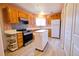 Well-lit kitchen with wood cabinets, stainless steel oven, and decorative backsplash at 4945 Twin Lakes Rd # 44, Boulder, CO 80301