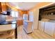 Efficient kitchen featuring modern appliances, a kitchen island, and handy laundry access at 4945 Twin Lakes Rd # 44, Boulder, CO 80301