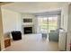 Bright living room featuring a fireplace, balcony access, and neutral-colored furnishings at 4945 Twin Lakes Rd # 44, Boulder, CO 80301