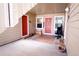 Covered outdoor patio featuring three doorways, ample space, and neutral-toned siding at 4945 Twin Lakes Rd # 44, Boulder, CO 80301