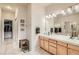 This bright bathroom features double sinks and a clear view into the walk-in closet at 3546 Broadlands Ln # 102, Broomfield, CO 80023