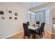 This bright dining room features a glass table, seating for six, and a large bay window for ample natural light at 3546 Broadlands Ln # 102, Broomfield, CO 80023