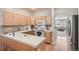 Charming kitchen with wood cabinets, modern appliances, tile countertops, and an open layout, ideal for cooking and entertaining at 3546 Broadlands Ln # 102, Broomfield, CO 80023