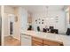Well-lit kitchen and breakfast nook featuring updated appliances, wood cabinets, and a dishwasher for added convenience at 3546 Broadlands Ln # 102, Broomfield, CO 80023