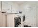 Efficient laundry room features modern appliances, including washer and dryer, and overhead shelving at 3546 Broadlands Ln # 102, Broomfield, CO 80023